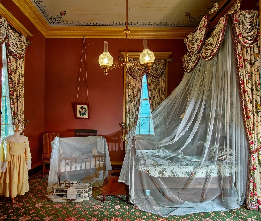 A guest room with a large bed and soft lighting